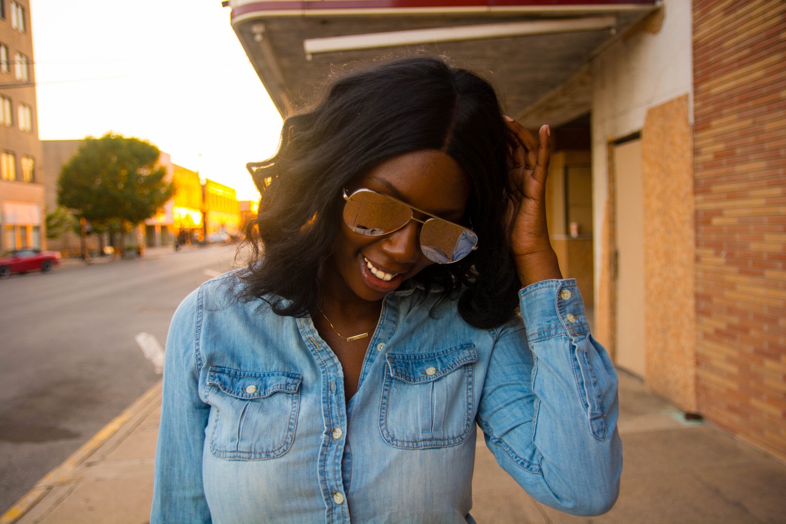 Tasha Robinson Imperfect Concepts wearing: Sunglasses: Quay X Desi, Shirt: Target, Jeans: American Eagle, Shoes: Charlotte Olympia and Bag: Balenciaga