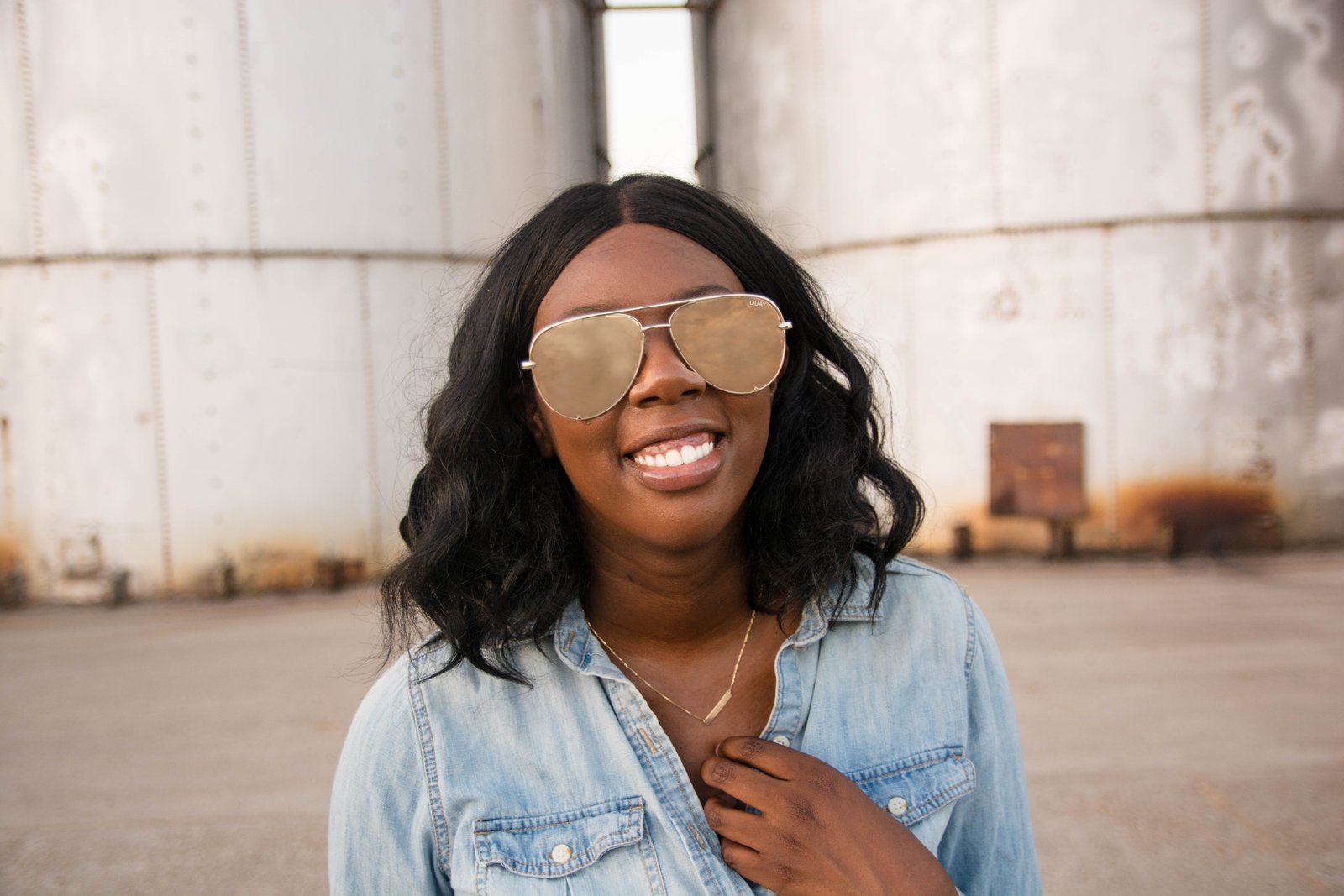 Tasha Robinson Imperfect Concepts wearing: Sunglasses: Quay X Desi, Shirt: Target, Jeans: American Eagle, Shoes: Charlotte Olympia and Bag: Balenciaga